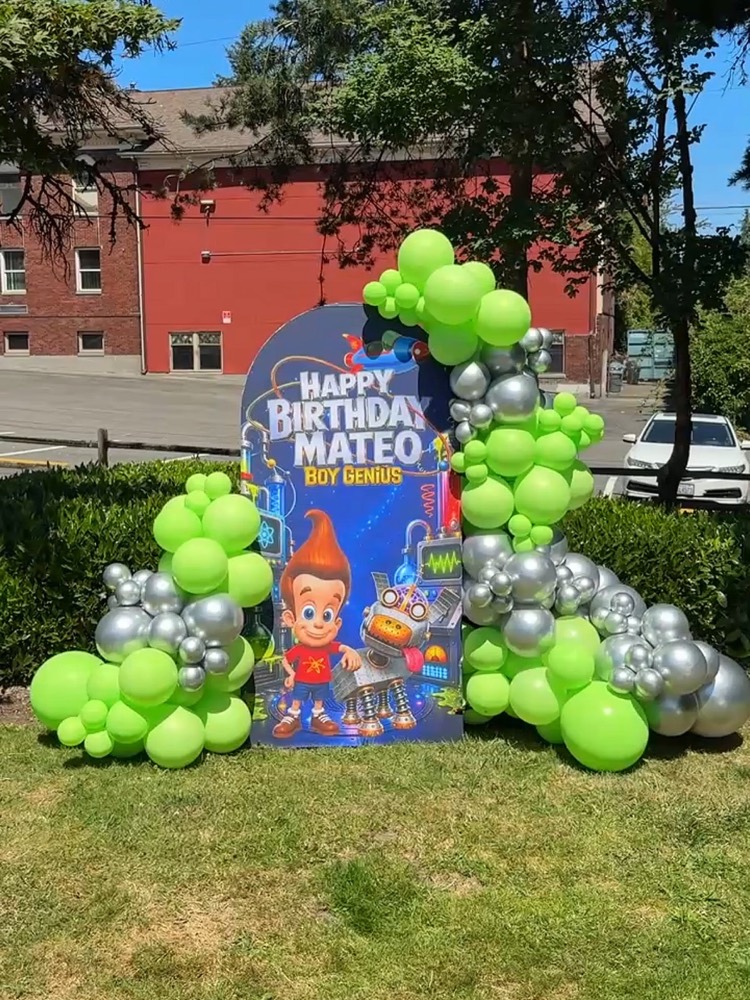 Jimmy Neutron birthday panel with custom vinyl wrap and green balloon arch