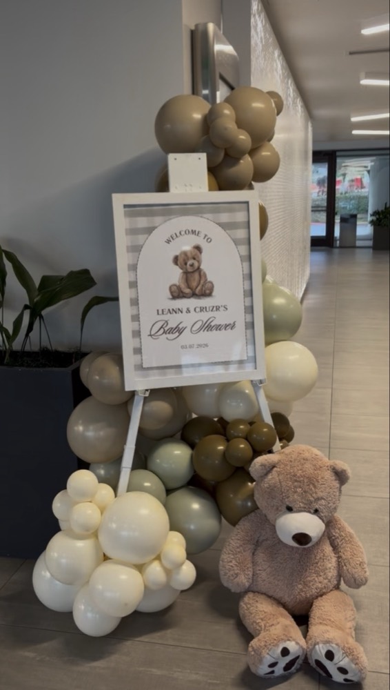 Teddy bear baby shower welcome sign with neutral balloon garland