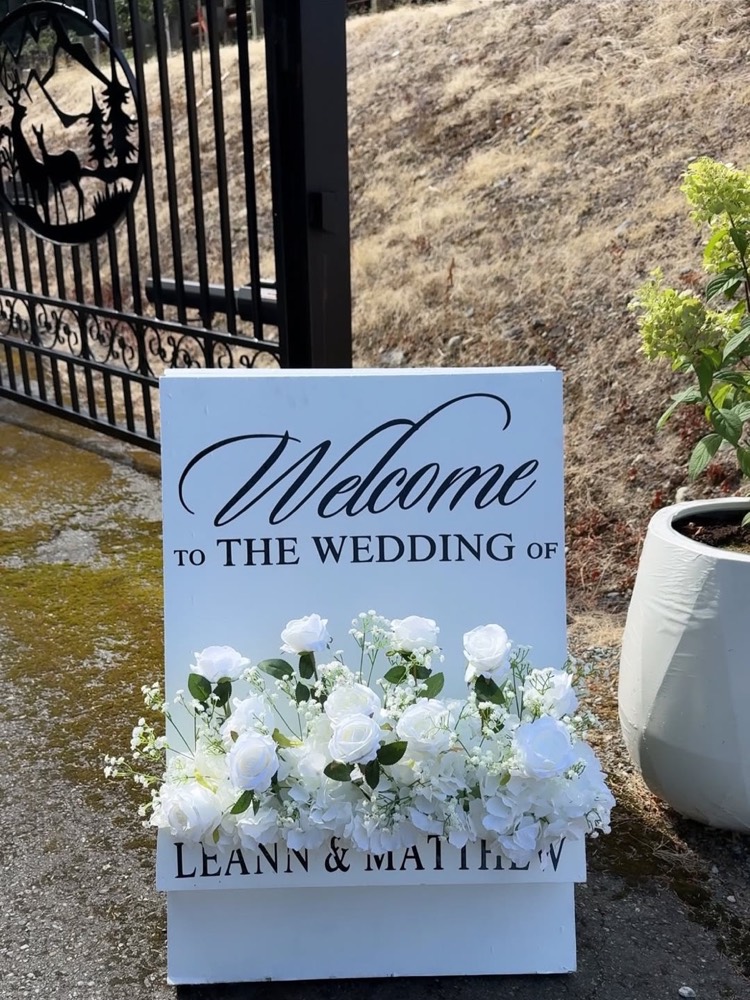 Custom welcome to the wedding sandwich sign with white florals